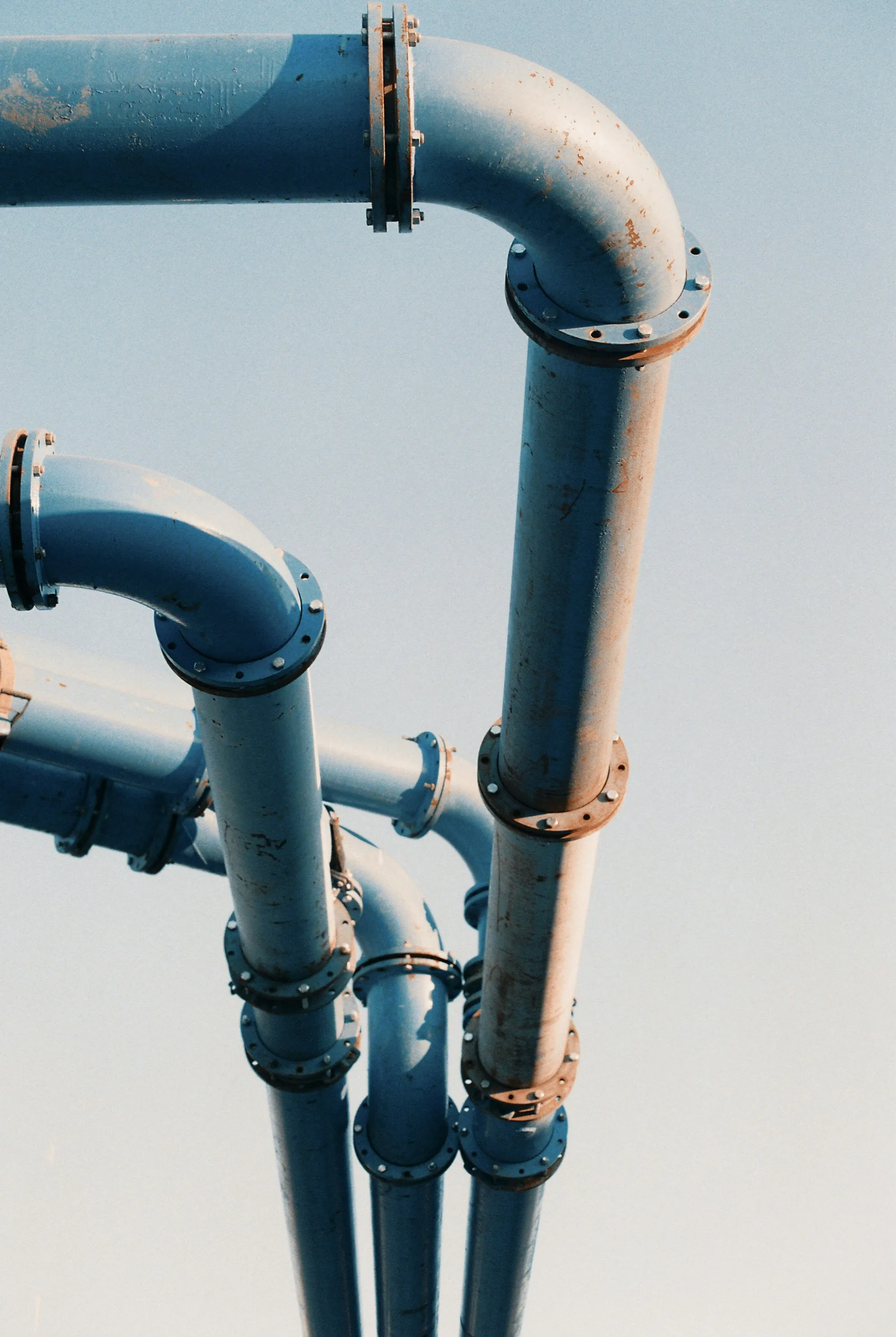 Whole-House Water Filtration in Lake Forest, CA Blue and copper water pipes with elbow fittings
