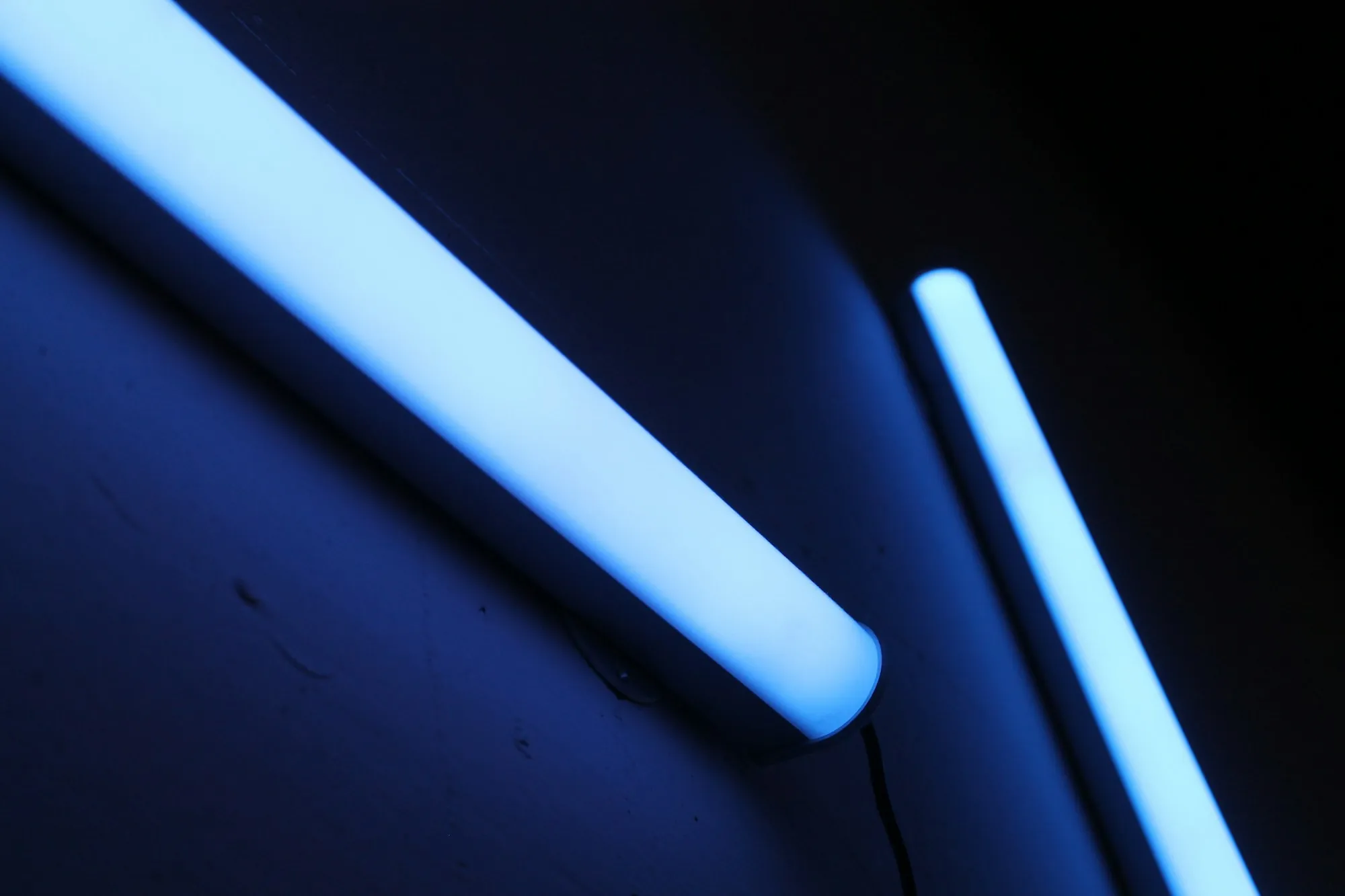 UV Water Purification in Lake Forest, CA Two glowing blue light tubes in the dark