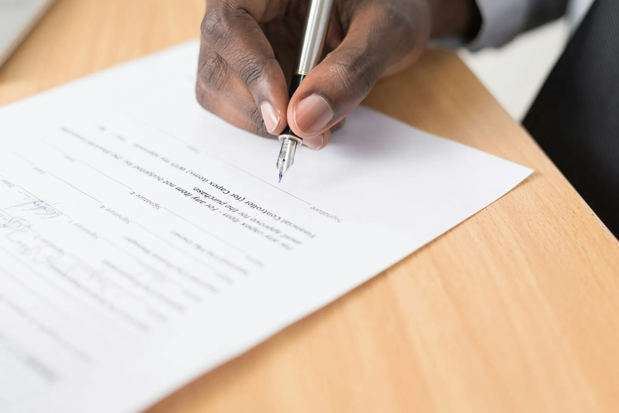 Terms of Service Hand writing on a sheet of paper on a wooden desk