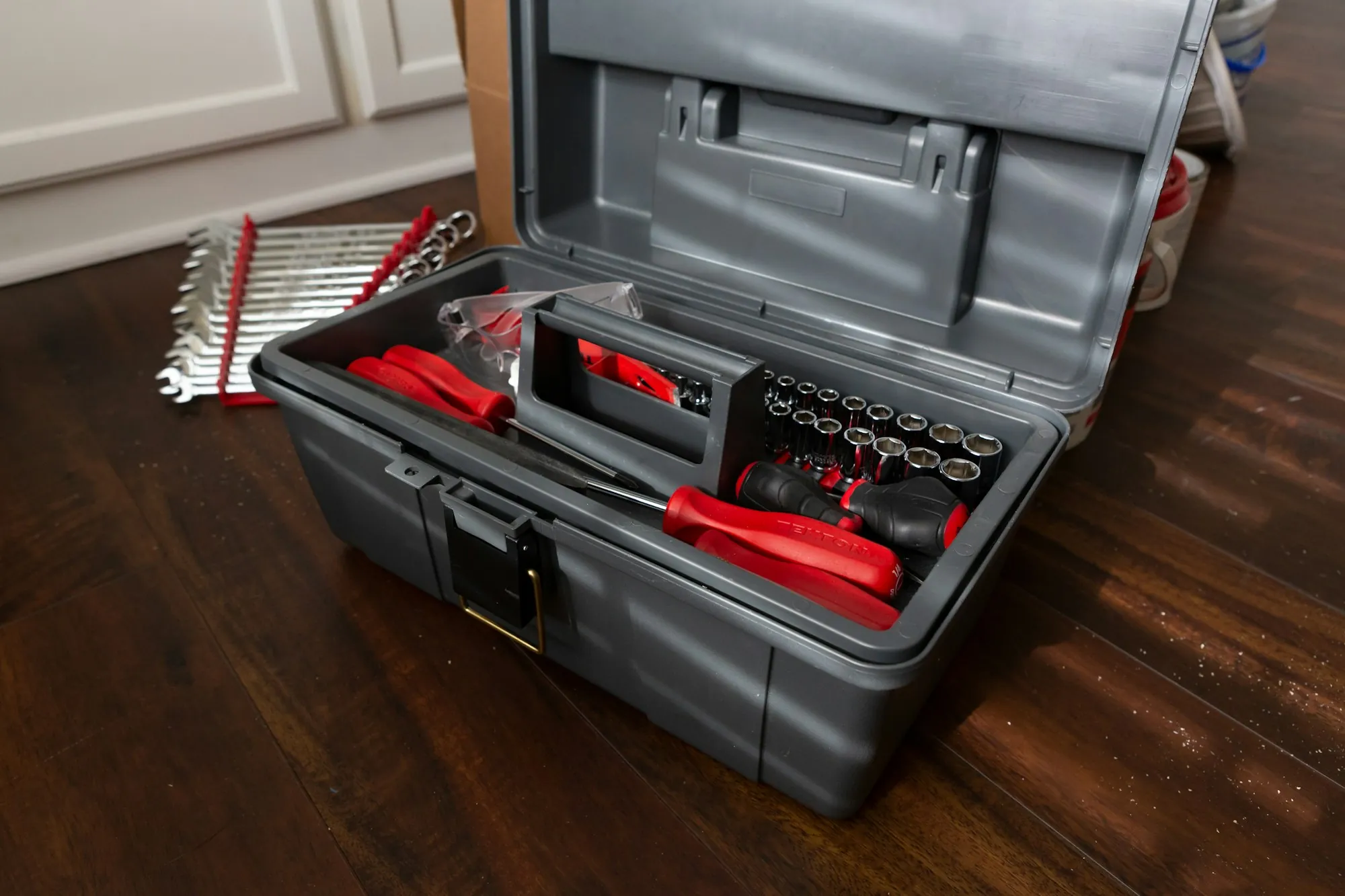 About Lake Forest Water Pros Open grey toolbox with red-handled tools on a wooden floor