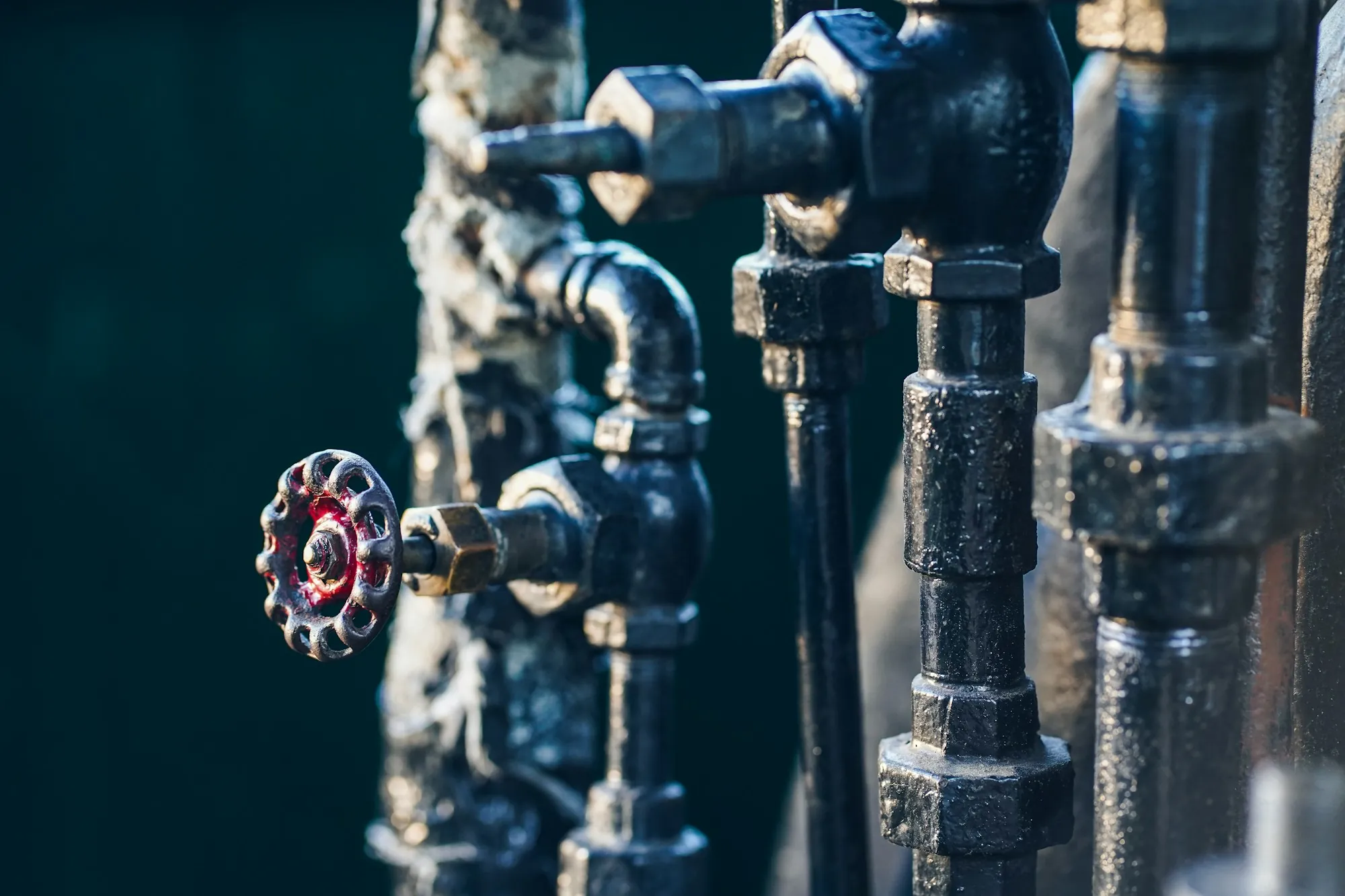 Credentials You Can Count On Black water pipes with a red valve wheel