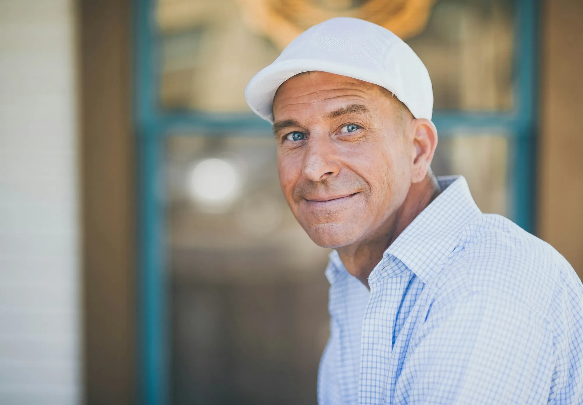 Local Water Specialists, Not a National Call Center Smiling man in a white cap and a checked shirt