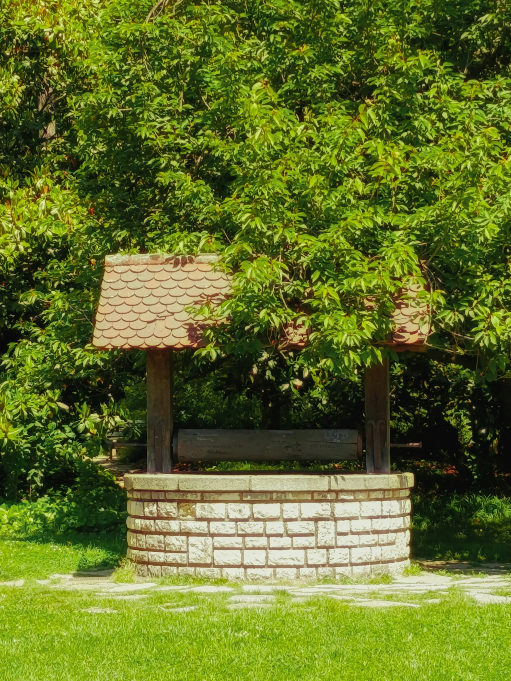 Well Water Filtration & Treatment in Lake Forest, CA Stone well with a wooden roof in a green garden