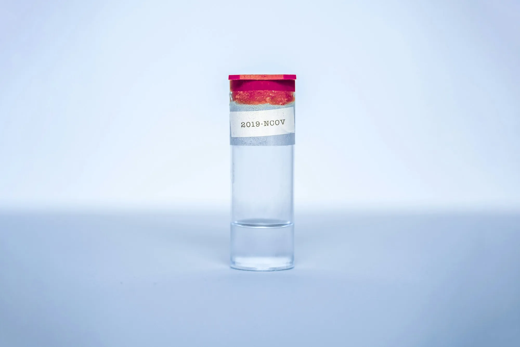 Water Testing & Analysis in Lake Forest, CA Clear sample bottle of water with a red lid
