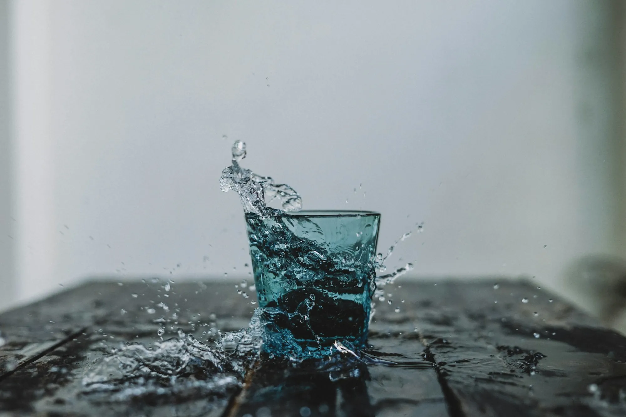 Find Out What Is Really in Your Water Water splashing out of a clear glass on a dark surface